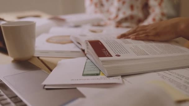 University Student At Table Of Books — Vídeo de stock