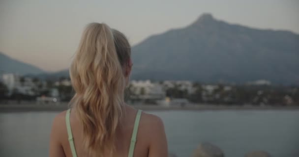 Woman Walking In Sunset Along Promenade By Sea — Vídeos de Stock