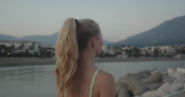 Woman Walking In Sunset Along Promenade By Sea — Vídeos de Stock