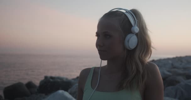 Woman Listening To Music By Sea At Sunset — Vídeos de Stock