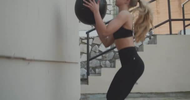 Young Woman Squatting To Throw And Catch Medicine Ball — Wideo stockowe