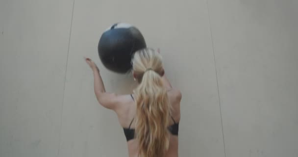 Young Woman Squatting To Throw And Catch Medicine Ball — ストック動画