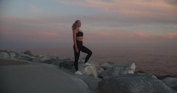 Young Athlete Walking Away From Rocks At Sunset — Vídeos de Stock