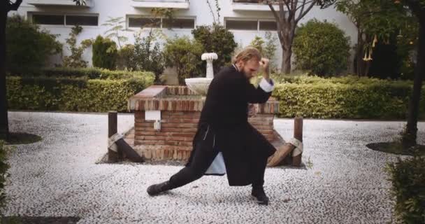 Man Performing Martial Arts In Garden — Stock Video