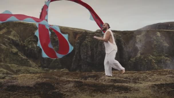 Man Wearing White Barefoot Swaying A Thread Attached To A Sheer Fabric — Stock Video
