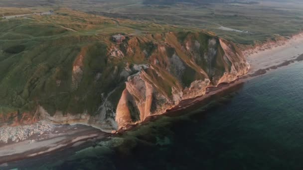 Beautiful Mountain Covered In Green Grass on the Shoreline of the Calm Ocean — Stock Video