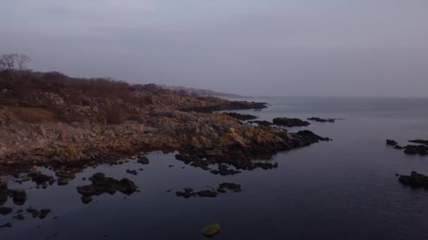 Magnificent Rocky Shore Under the Pale Blue Sky on a Serene Ocean — Stock Video