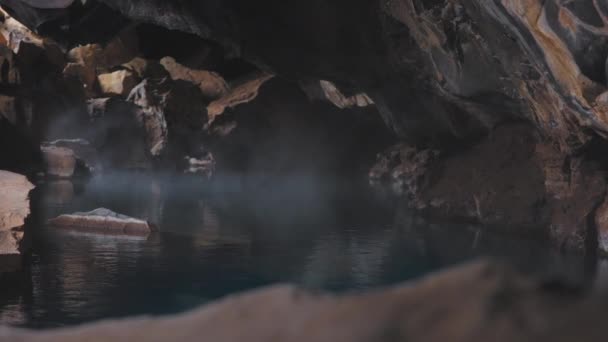 Steam Rising From Pool In Cave Of Volcanic Rock In Iceland — стокове відео