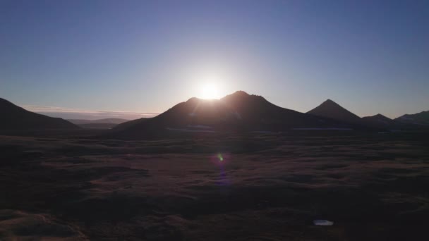 Hory se skalnatými rozlehlými zeměmi pokrytými trávou a modrou oblohou a žlutým sluncem — Stock video