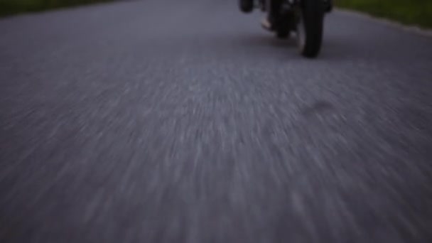 Revealing Shot From Concrete Road to Motorcycle Rider and Lush Trees and Grass — Stockvideo