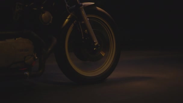 Awesome Closeup Shot of a Motorcycle Front Wheel on a Dark Background — Stockvideo