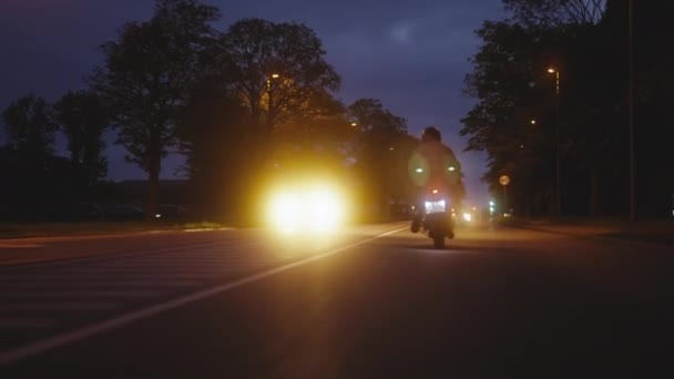 Person Riding on a Motorcycle on a Road in the Backdrop of Street Lights — ストック動画