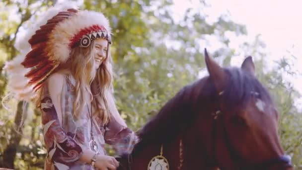 Young Woman In Headdress Riding Horse In Sunlit Forest — Stockvideo