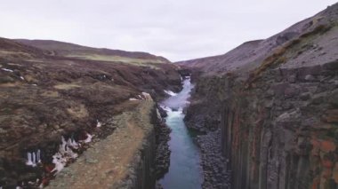 Göz kamaştıran Mavi Buzul Nehri ve Açık Gökyüzü ile Basalt Kaya SütunuName