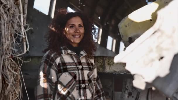 Entlarvende Aufnahme eines schönen weiblichen Modells in einem ikonischen Flugzeugwrack in Island — Stockvideo