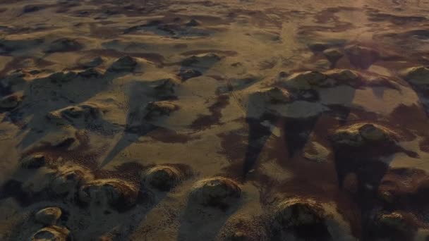 Tiro de aviones no tripulados de tierras rocosas con grandes sombras siendo lanzadas contra el sol — Vídeos de Stock