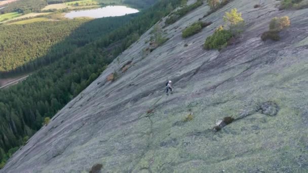 Drone Of Rock Climber Using Ropes To Climb Mountain Slope — Stock Video