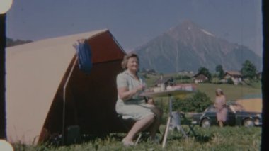 Bir çift, 8mm 'lik statik kamera açısıyla çekilen ve sakin ve rahat bir görsel ruh hali sergileyen bir çadırın yanında piknik yapmayı seviyor..