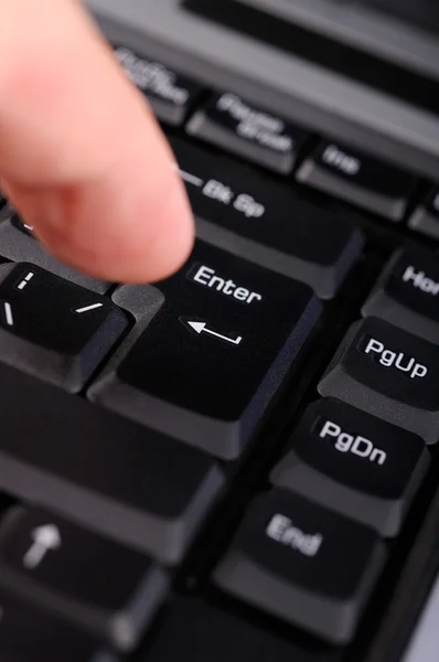 Finger hitting the ENTER key — Stock Photo, Image