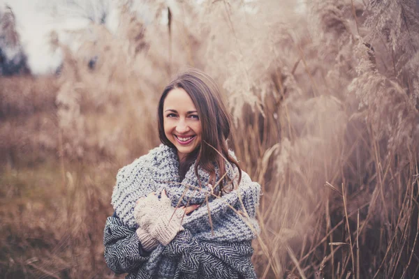 Girl in casual warm clothing in reeds