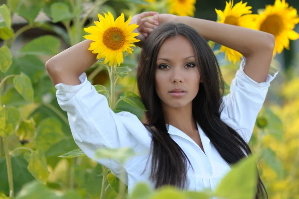 Retrato de una hermosa chica con flores en el verano —  Fotos de Stock