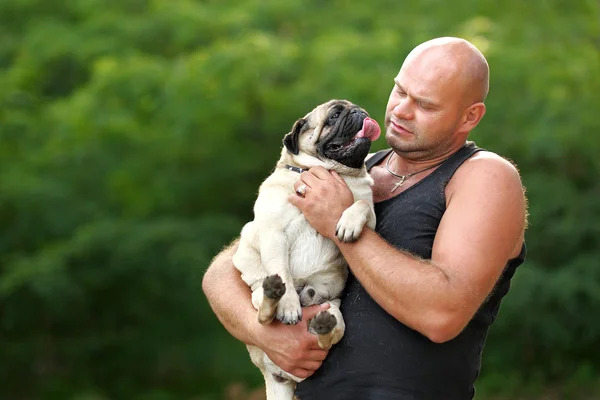Portrait of a man and his dog pug — Stock Photo, Image