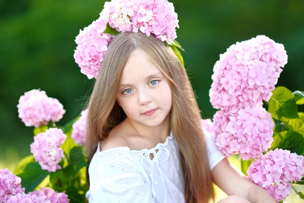 Portrait of little girl with flowers hydrangea — Stock Photo, Image