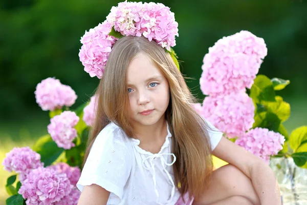 Portrait of little girl with flowers hydrangea — Stock Photo, Image