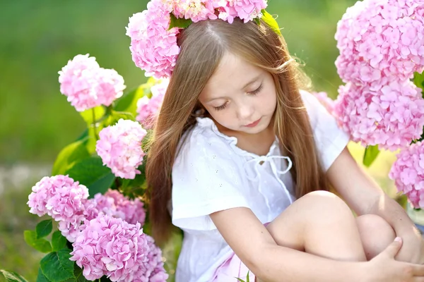 Portrait of little girl with flowers hydrangea — Stock Photo, Image