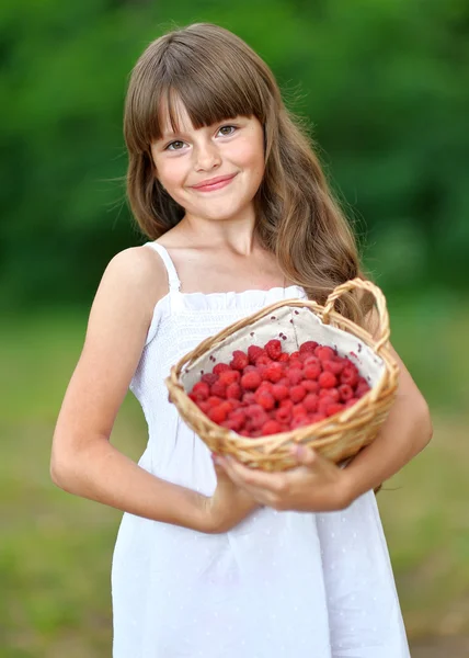 Portrait of a beautiful little girl with raspberries — Stock Photo, Image