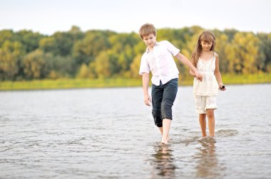 Bir erkek ve kız sahilde oynarken portre