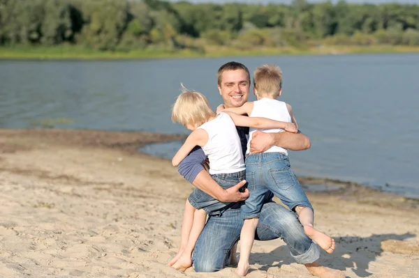 Portrait of a father and two sons on the beach — Stock Photo, Image