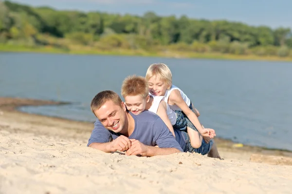 一位父亲和在海滩上的两个儿子的画像 — 图库照片