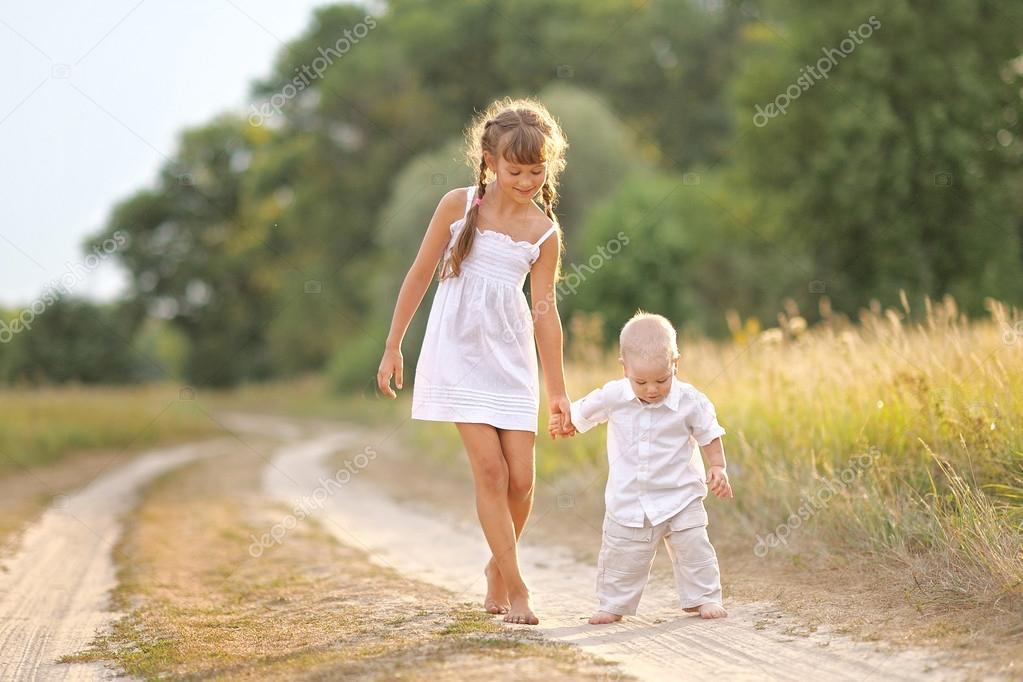 Small Brother and sister in summer nature 