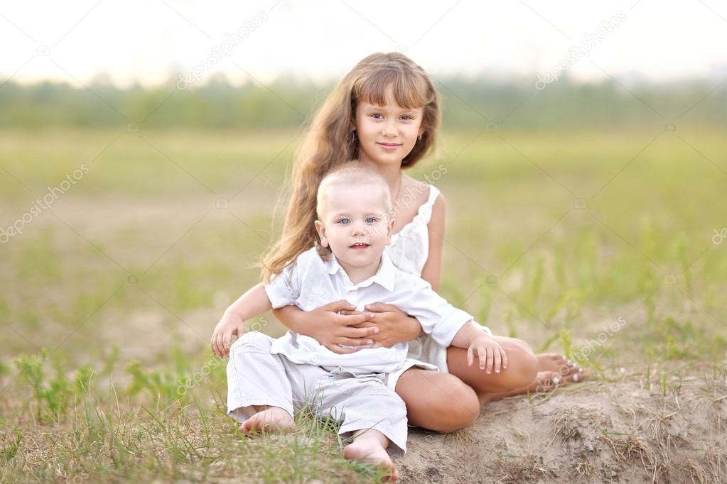 Small Brother and sister in summer nature 