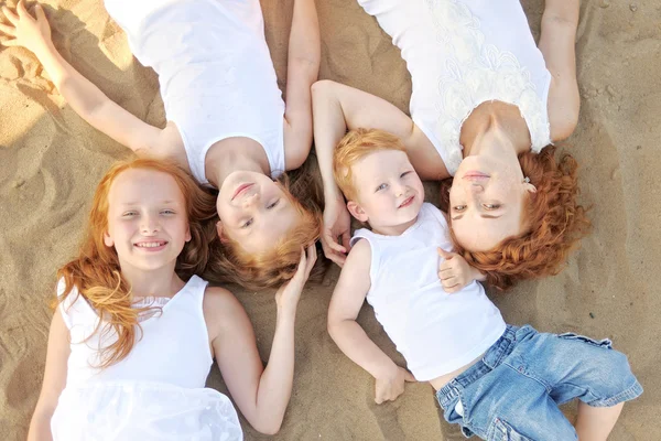 Family portrait of mother and of a boy and his two sisters loved — стоковое фото