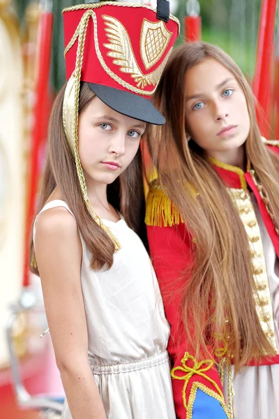 Portrait of two girls in the style of hussars — Stock Photo, Image