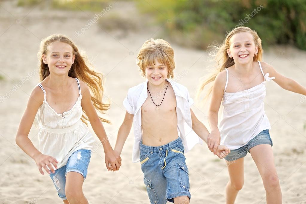 Portrait of children on the beach in summer