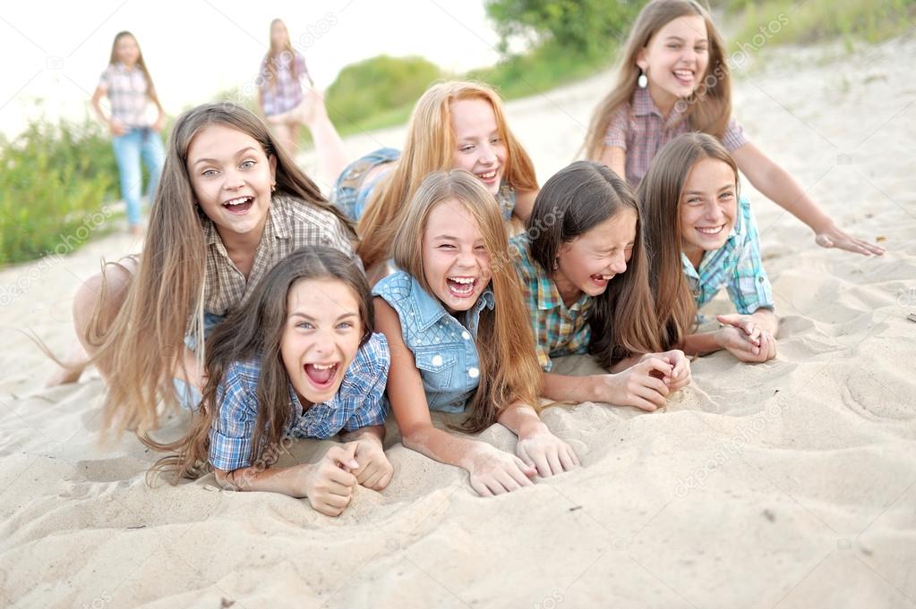 Portrait of joyful beautiful girlfriends on the nature