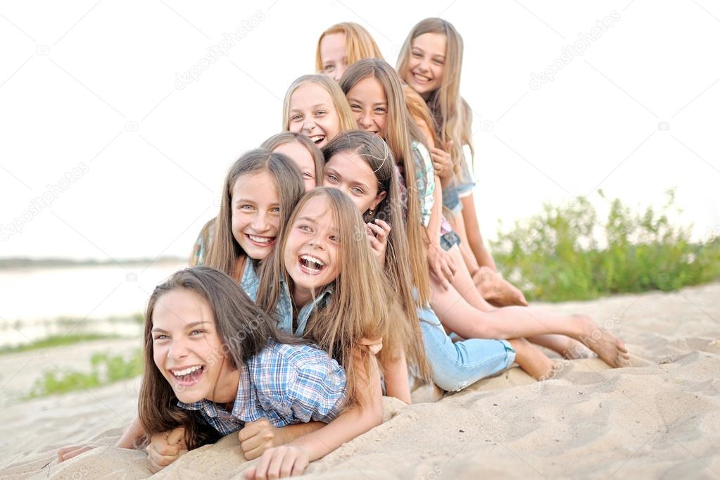 Portrait of joyful beautiful girlfriends on the nature