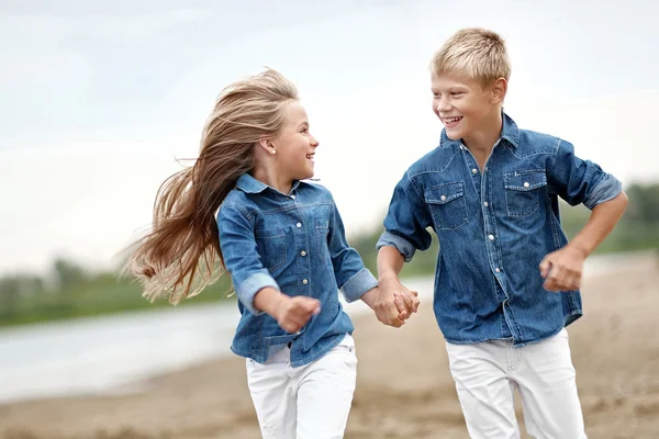 Portrait of a boy and girl on the beach in summer — Stock Photo, Image