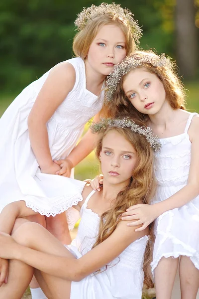 Portrait of two young girlfriends with flowers — Stock Photo, Image