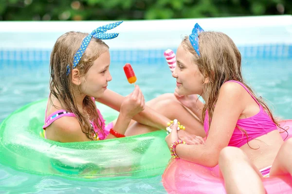 Portret van twee meisjes in een zwembad — Stockfoto