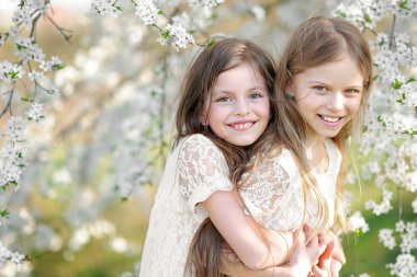 Portrait of two little girls girlfriends spring clipart