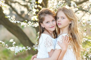 Portrait of two little girls girlfriends spring clipart