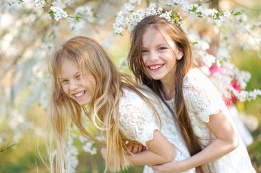 Portrait of two little girls girlfriends spring clipart