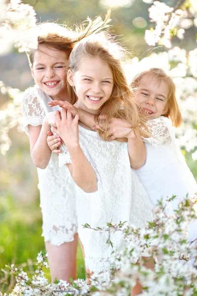 Portrait of little girls sisters in spring — Stock Photo, Image