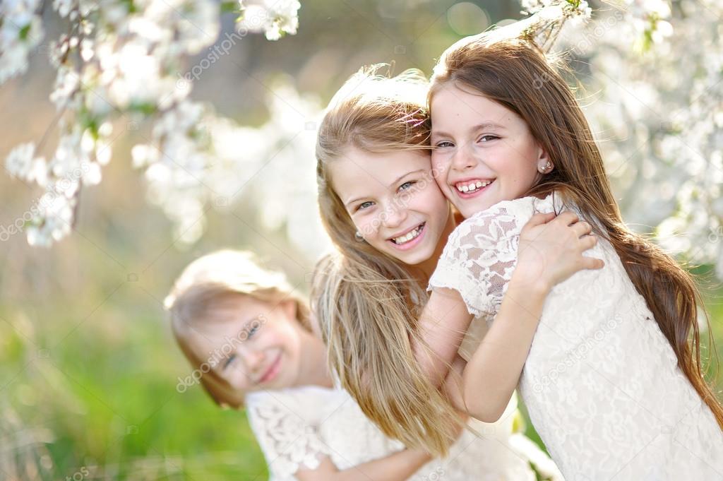 Portrait of little girls sisters in spring
