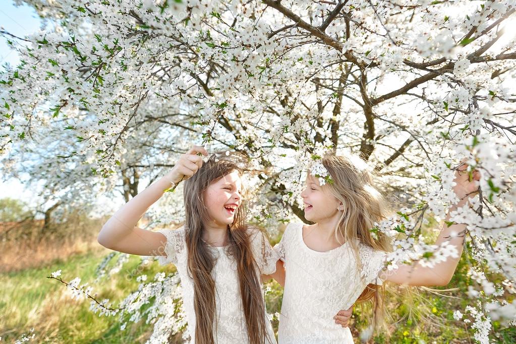 Portrait of two little girls girlfriends spring
