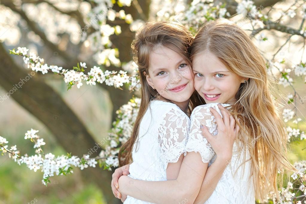 Portrait of two little girls girlfriends spring